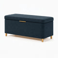 Banc coffre de rangement 120 x 45 x 50 cm en tissu bleu foncé avec pieds métalliques dorés